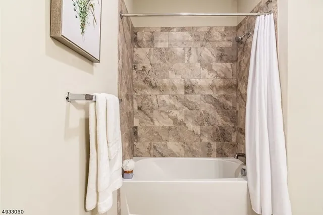 a bathroom with a shower and a bathtub