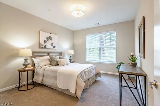 a bedroom with a bed and a table