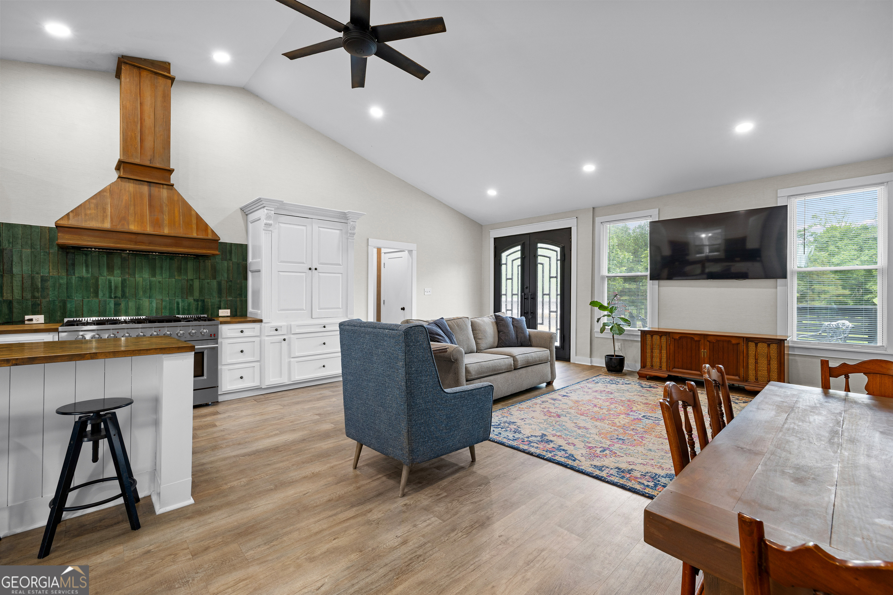 1329 Standing Rock Road Senoia, GA 30276 - Photo 13 of 77 a living room with furniture a ceiling fan and a fireplace