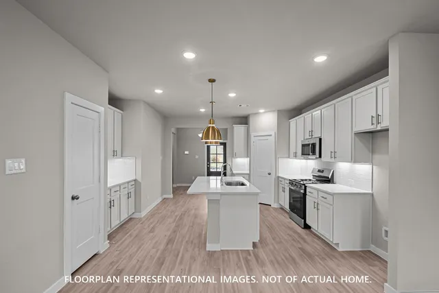 a open kitchen with kitchen island a sink stove and wooden floor