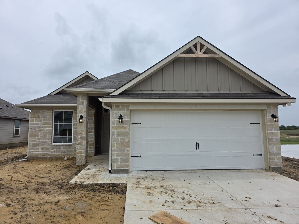 a front view of a house with garage