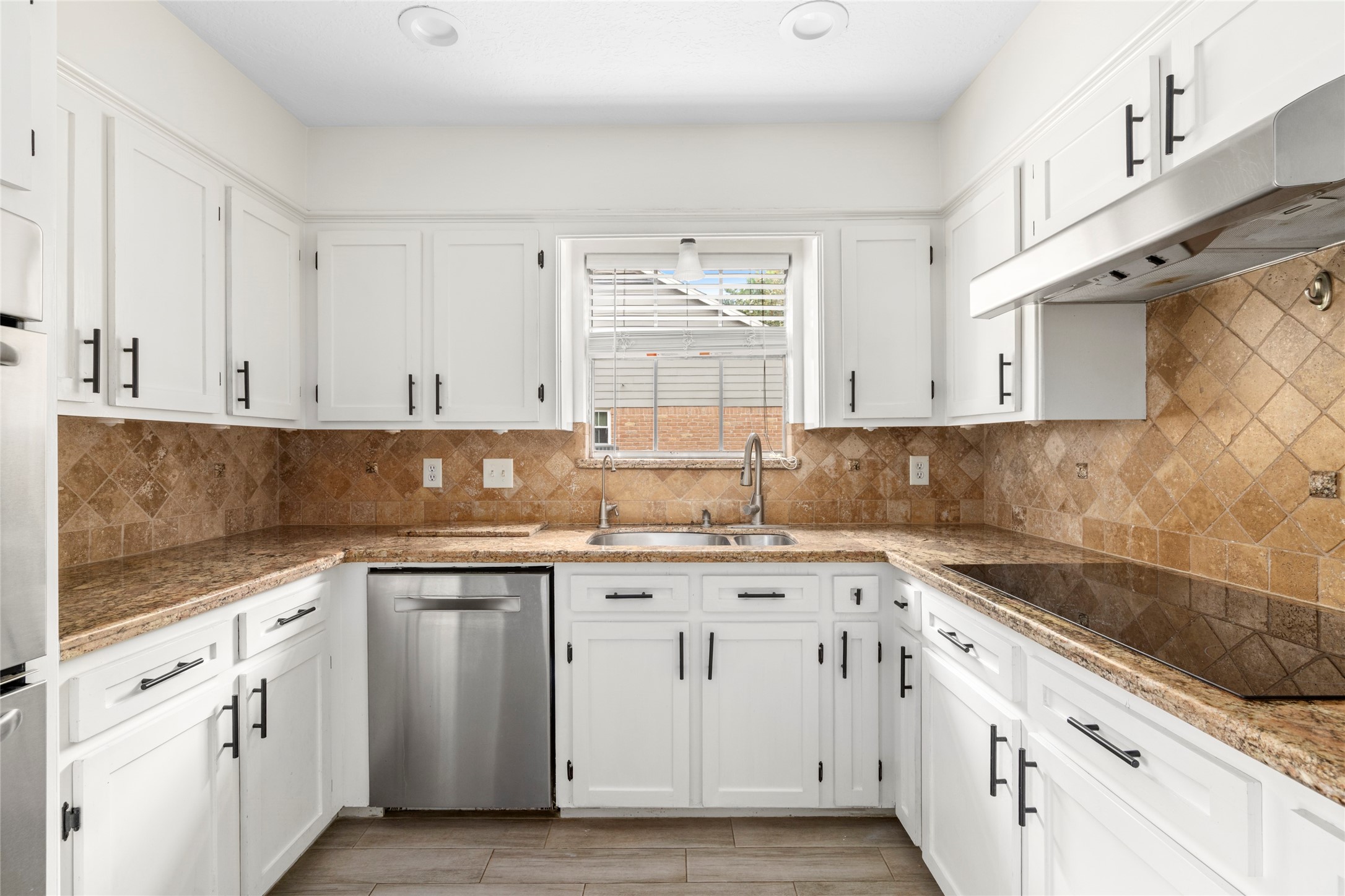 560 Landfall Lane Conroe, TX 77302 - Photo 22 of 41 The kitchen is updated with granite countertops, backsplash, and ample cabinetry.
