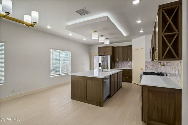 a kitchen with a sink stove and cabinets