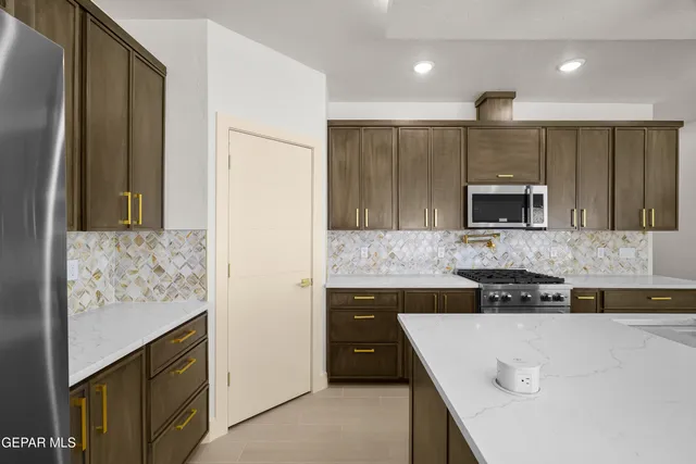 a kitchen with a sink stainless steel appliances and cabinets