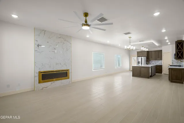 a living room with furniture and kitchen view