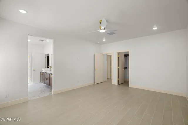 a spacious bathroom with a double vanity sink a mirror and shower