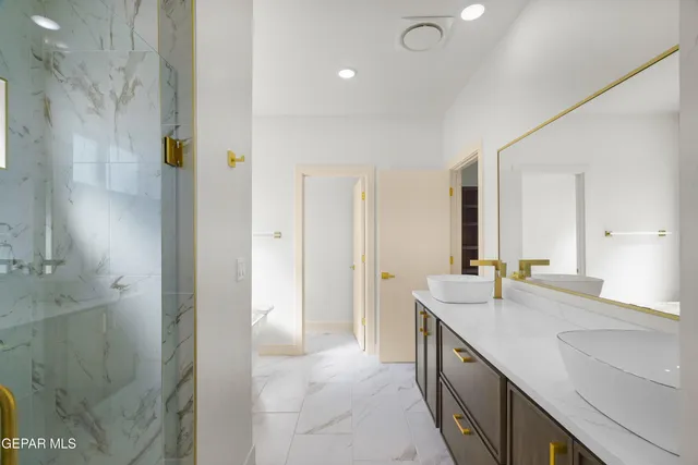 a bathroom with a double vanity sink and a mirror