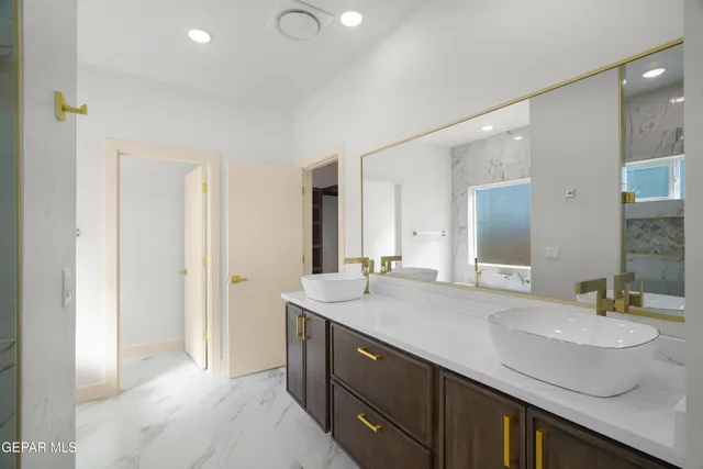 a spacious bathroom with a double vanity sink and a mirror