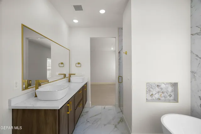 a bathroom with a bathtub and shower