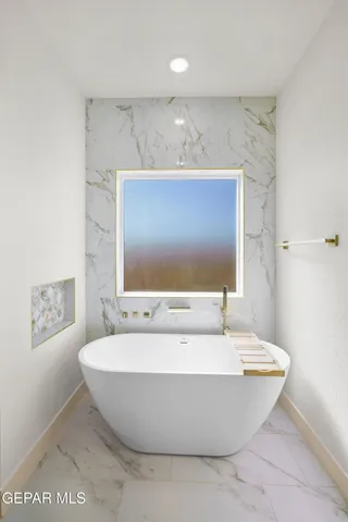 a bathroom with a bathtub and shower