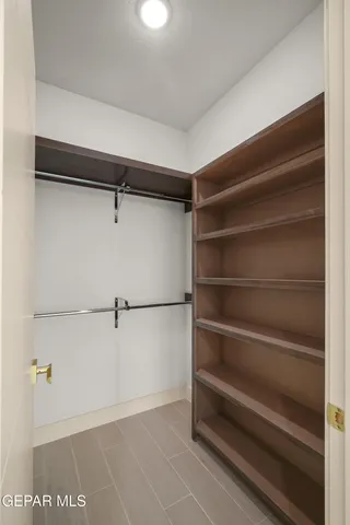 a view of a big room with closet and windows