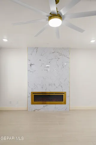 an open kitchen with a refrigerator and a microwave