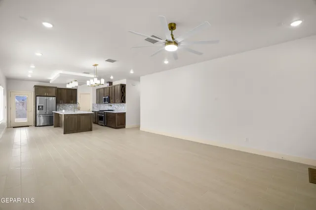 a large white kitchen with cabinets and stainless steel appliances