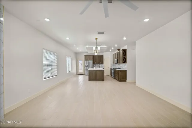 a large kitchen with stainless steel appliances granite countertop a stove and a sink