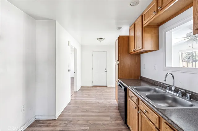a kitchen with stainless steel appliances granite countertop a sink and a refrigerator