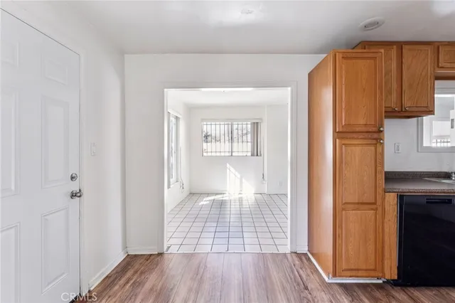 a view of a room with wooden floor and cabinet