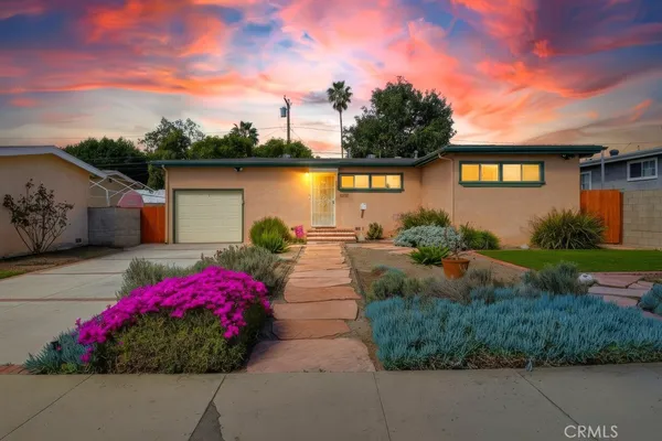 a view of a house with a yard and garden