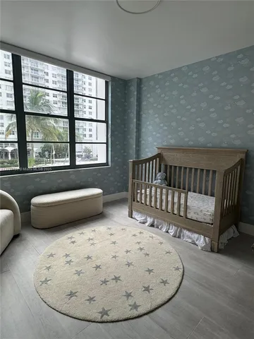 a view of a bedroom with furniture and window