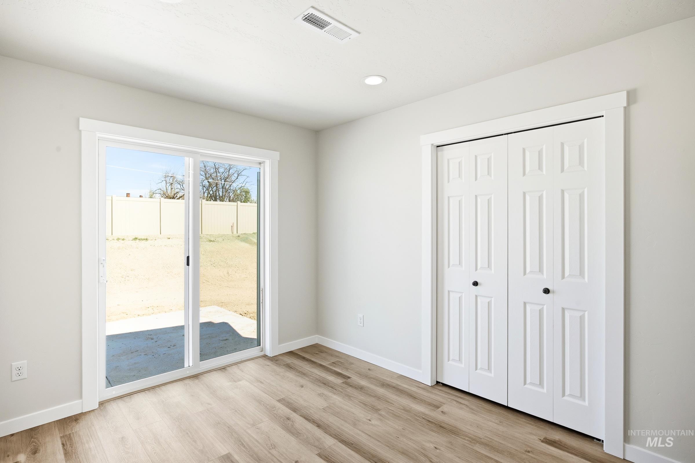 12841 Decatur Street Nampa, ID 83651 - Photo 6 of 30 Light wood-finish flooring complements the neutral wall tones and white trim