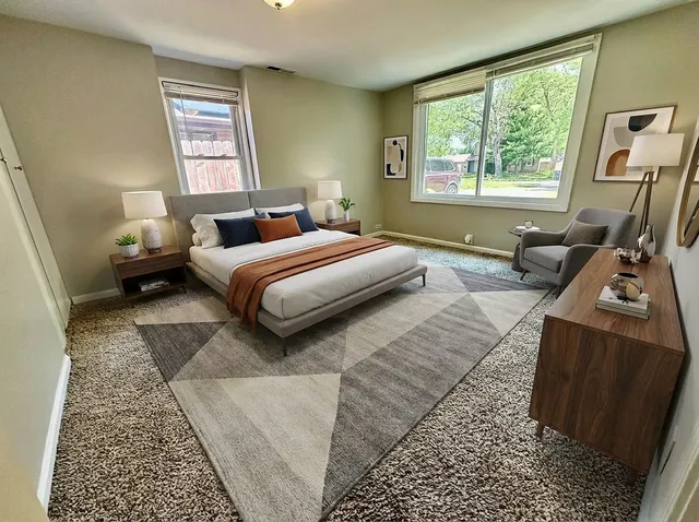 a bedroom with a bed couch and a window