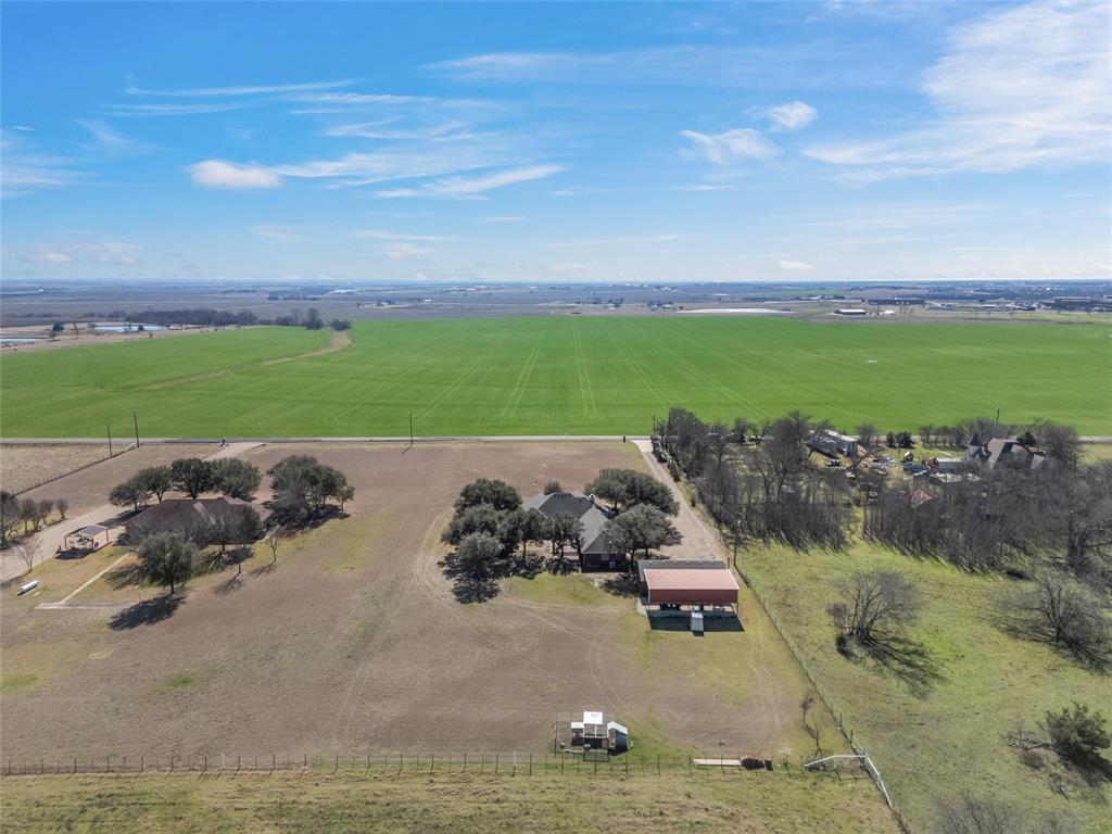 231 Trlica Road West, TX 76691 - Photo 35 of 36 This aerial view highlights the back of the property, showcasing expansive open land and rural surroundings. Wide-open views of the surrounding countryside emphasize the privacy and versatility this property offers.
