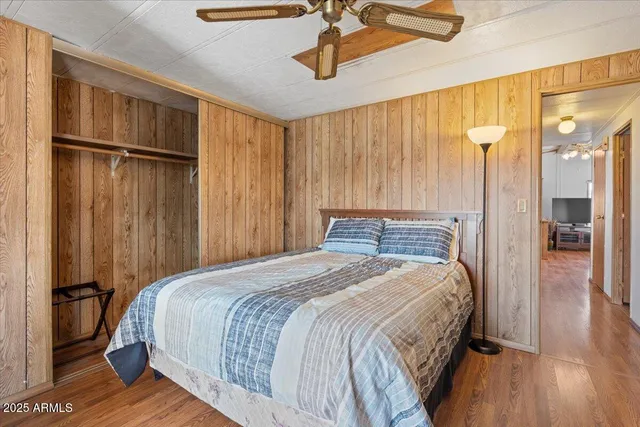 a bedroom with a large bed and a chandelier
