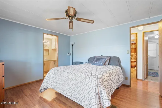a bedroom with a bed and wooden floor