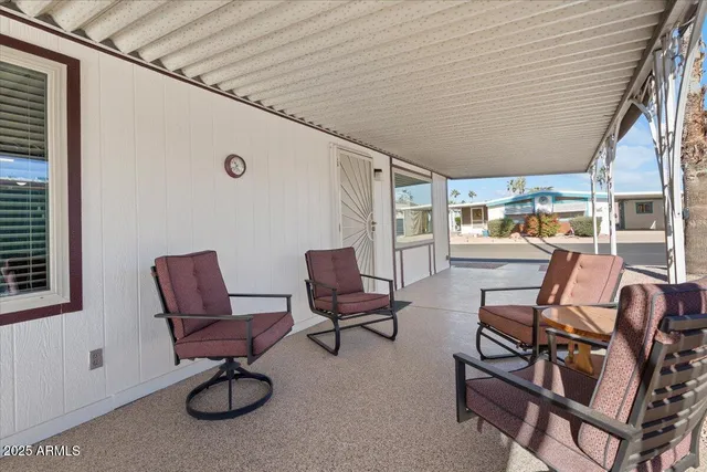 a building outdoor space with patio furniture and a potted plant