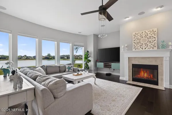 a living room with furniture a fireplace and a flat screen tv