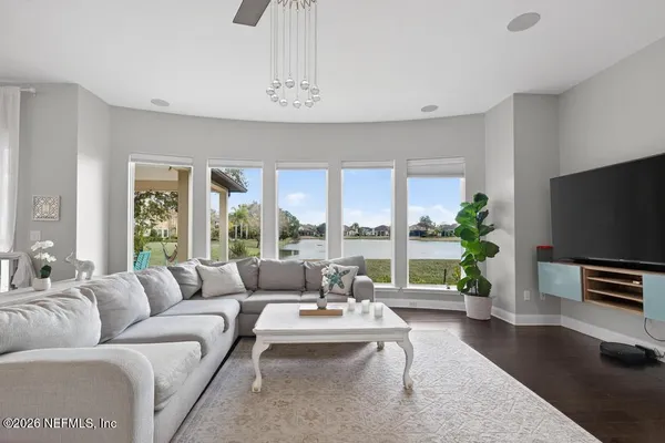 a view of a dining room with furniture wooden floor and chandelier
