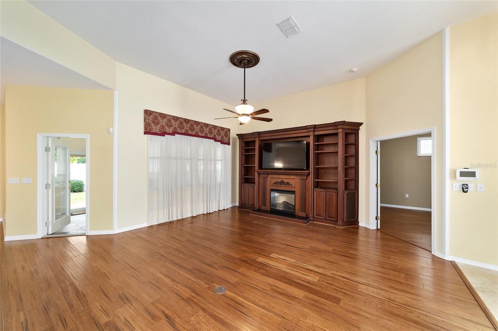 11017 Southwest 71st Terrace Road Ocala, FL 34476 - Photo 12 of 49 a view of an empty room with wooden floor
