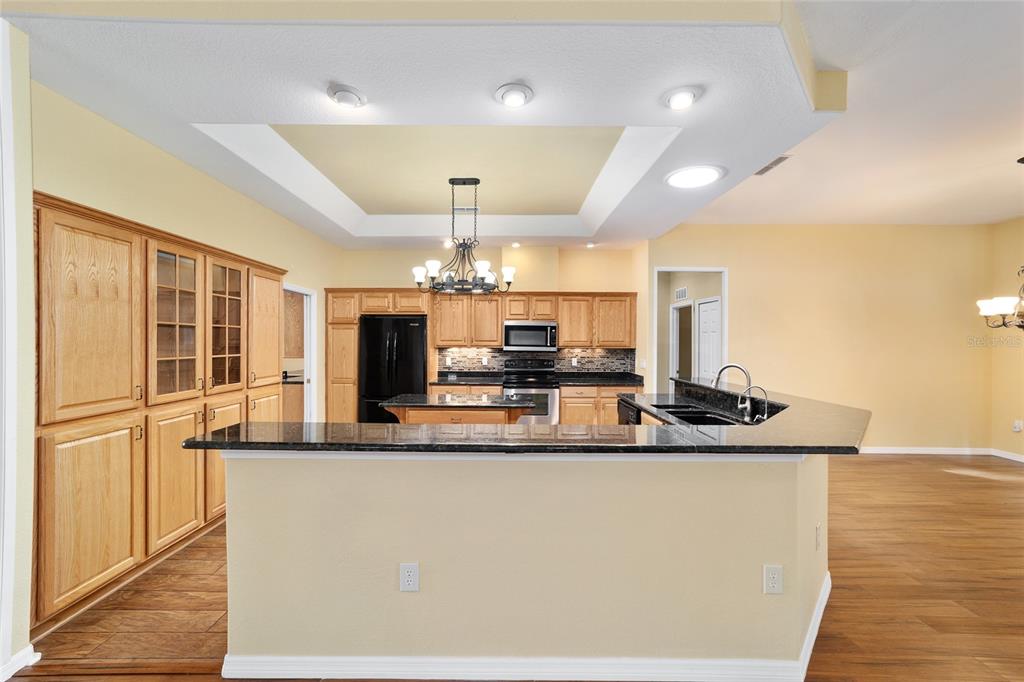 11017 Southwest 71st Terrace Road Ocala, FL 34476 - Photo 18 of 49 a large kitchen with a counter space a sink appliances and cabinets