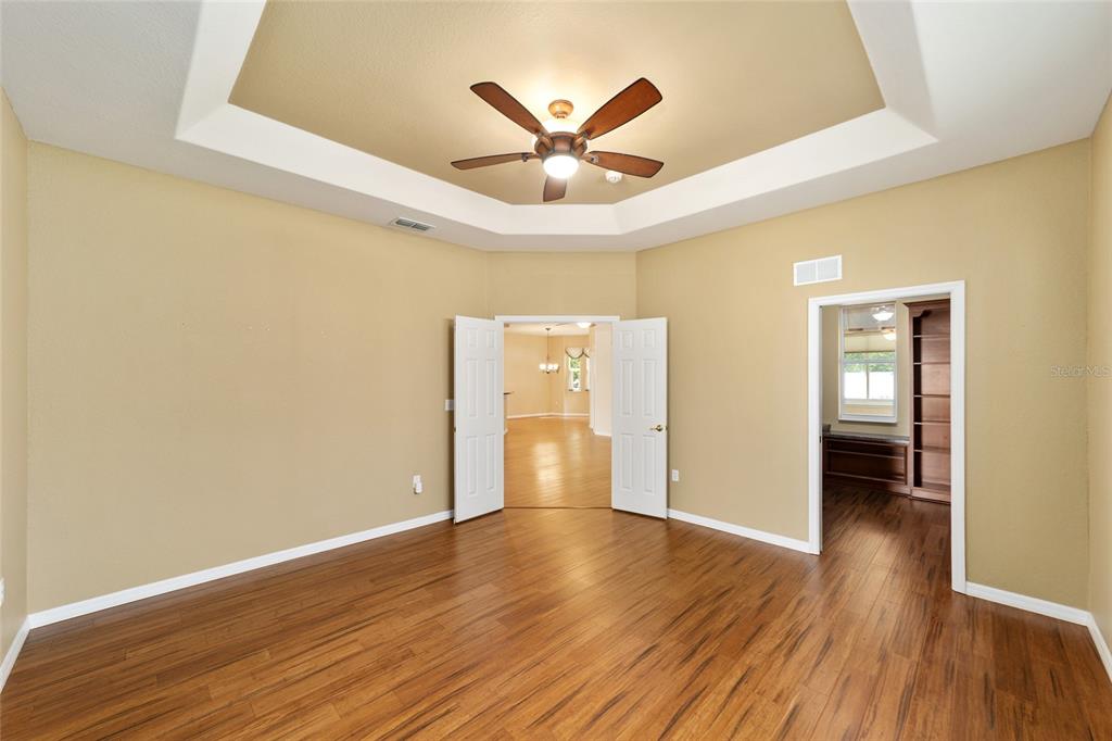 11017 Southwest 71st Terrace Road Ocala, FL 34476 - Photo 25 of 49 a view of an empty room with wooden floor