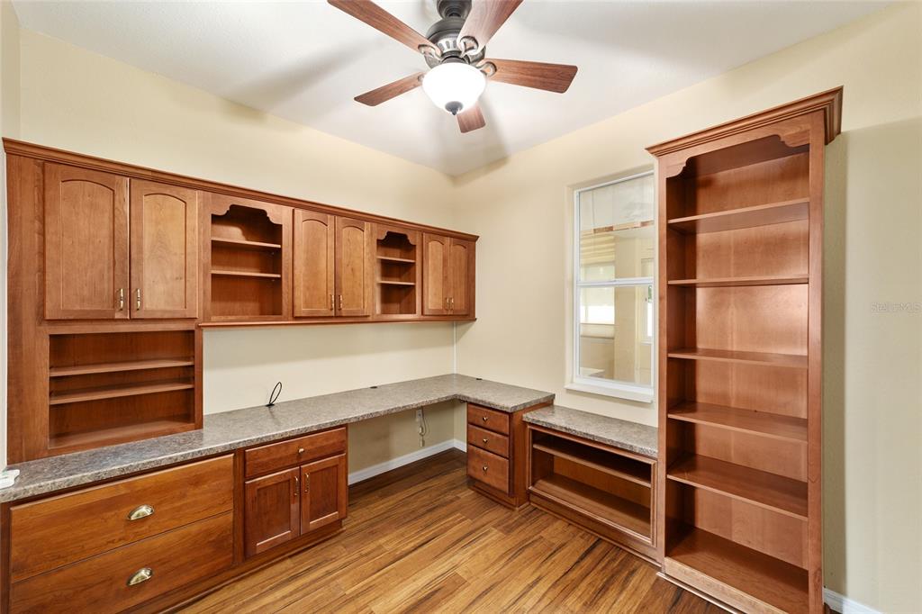 11017 Southwest 71st Terrace Road Ocala, FL 34476 - Photo 26 of 49 a kitchen with stainless steel appliances cabinets and a wooden floor