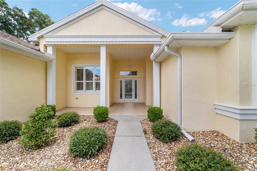 11017 Southwest 71st Terrace Road Ocala, FL 34476 - Photo 6 of 49 a front view of a house with garden