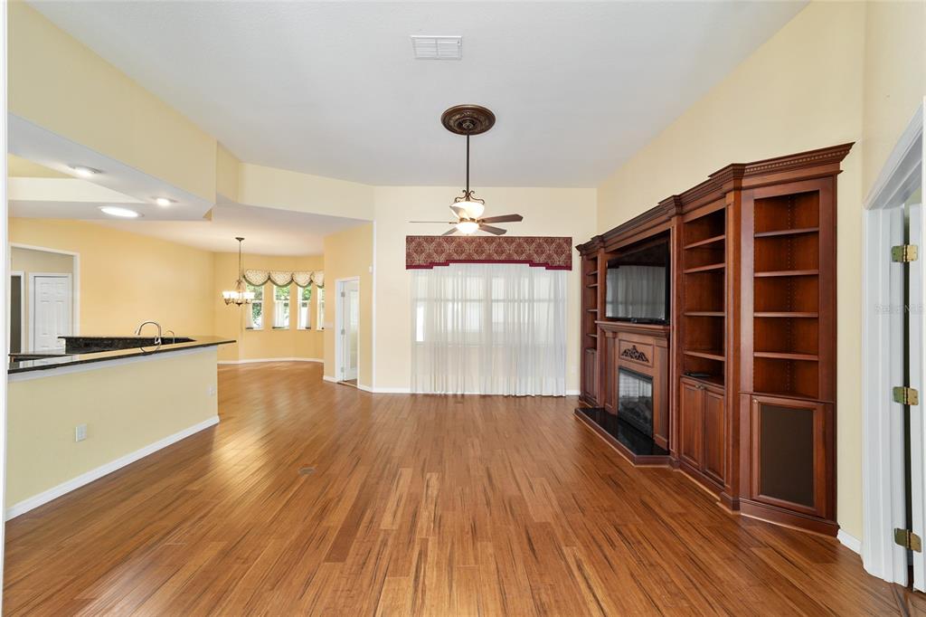 11017 Southwest 71st Terrace Road Ocala, FL 34476 - Photo 9 of 49 a view of empty room with wooden floor and fan
