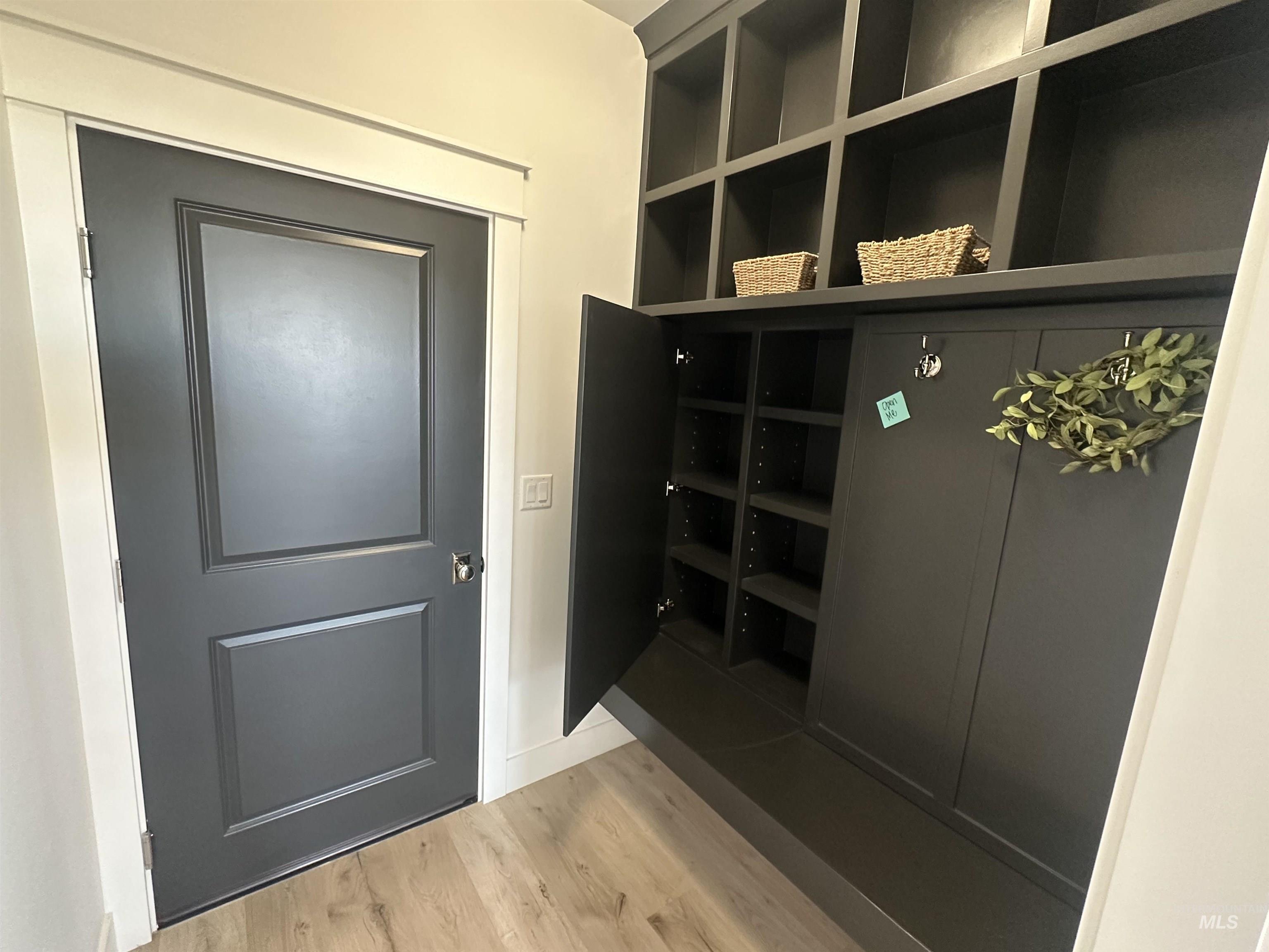 3035 Lake View Twin Falls, ID 83301 - Photo 10 of 41 Built-in storage bench with overhead cubbies, wall hooks, and wood-finish flooring