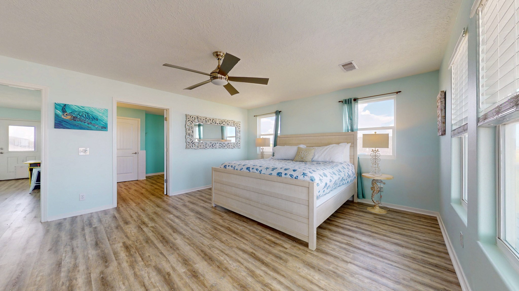 1822 Redfish Lane Crystal Beach, TX 77650 - Photo 12 of 28 a bedroom with a bed and wooden floor
