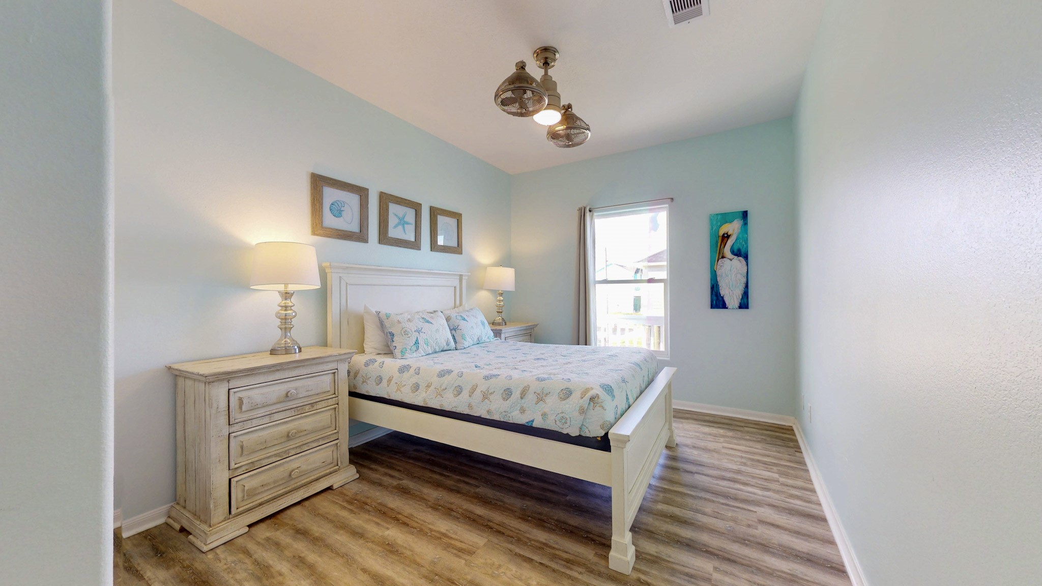 1822 Redfish Lane Crystal Beach, TX 77650 - Photo 20 of 28 a bedroom with a bed and a chandelier