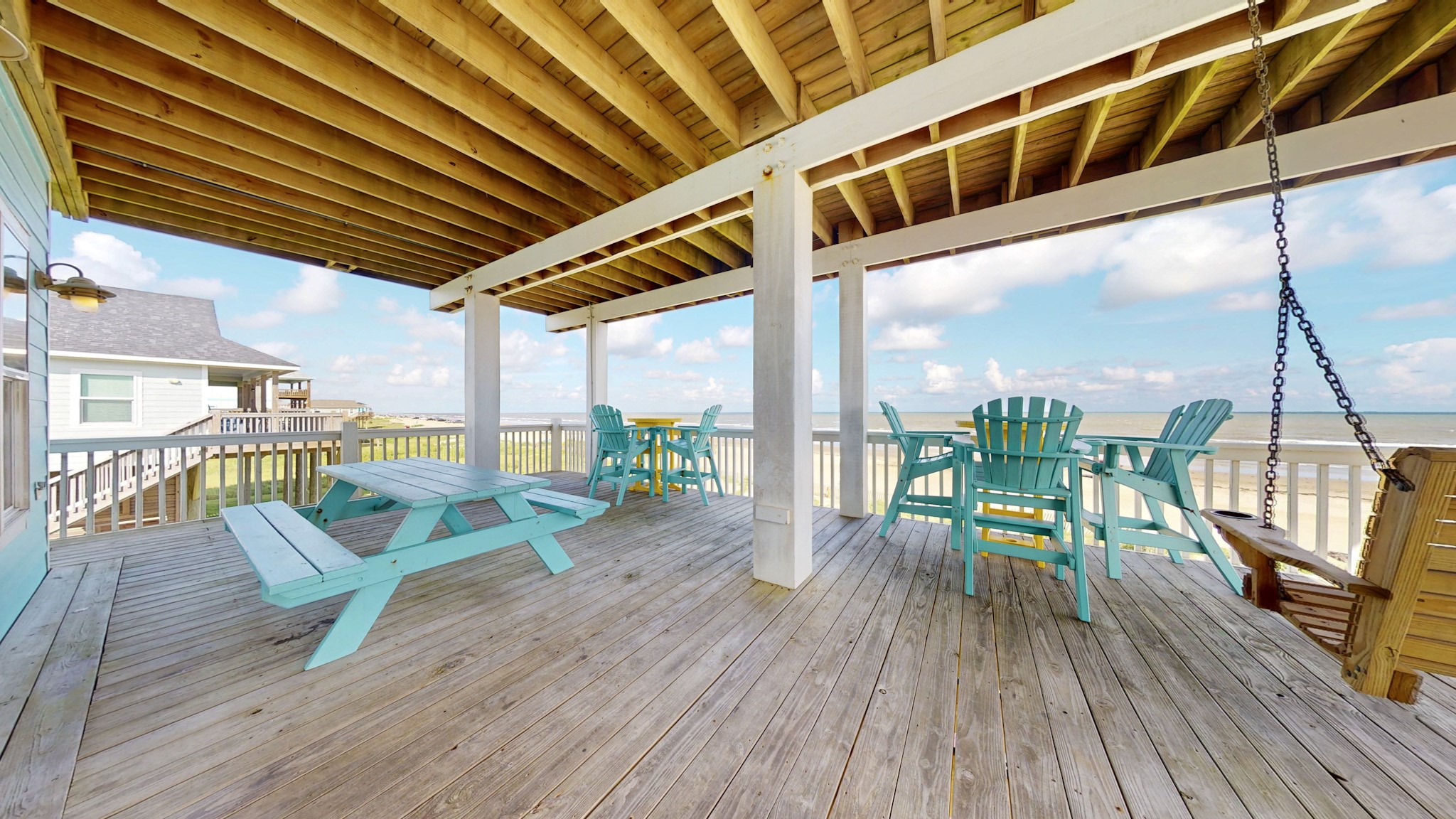 1822 Redfish Lane Crystal Beach, TX 77650 - Photo 25 of 28 a roof deck with table and chairs wooden floor and fence
