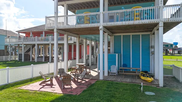 a view of a chair and table in backyard of the house