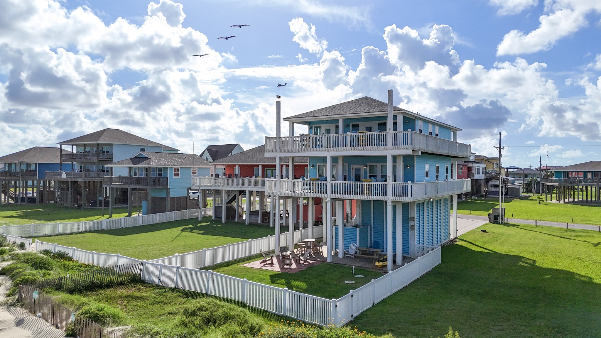 1822 Redfish Lane Crystal Beach, TX 77650 - Photo 5 of 28 a view of a house with a big yard and large trees