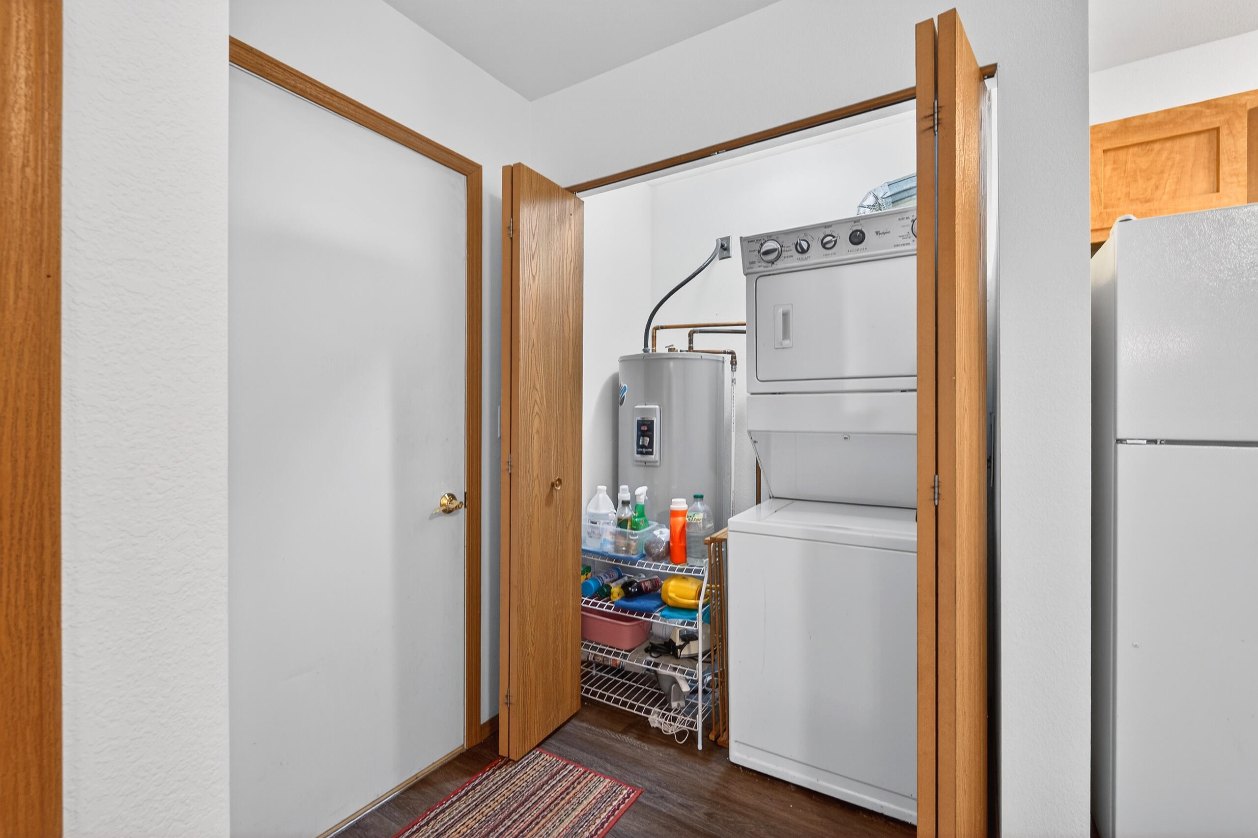112 Market Square, Unit 152 Wautoma, WI 54982 - Photo 13 of 85 Laundry and water heater in closet off kitchen and garage door.