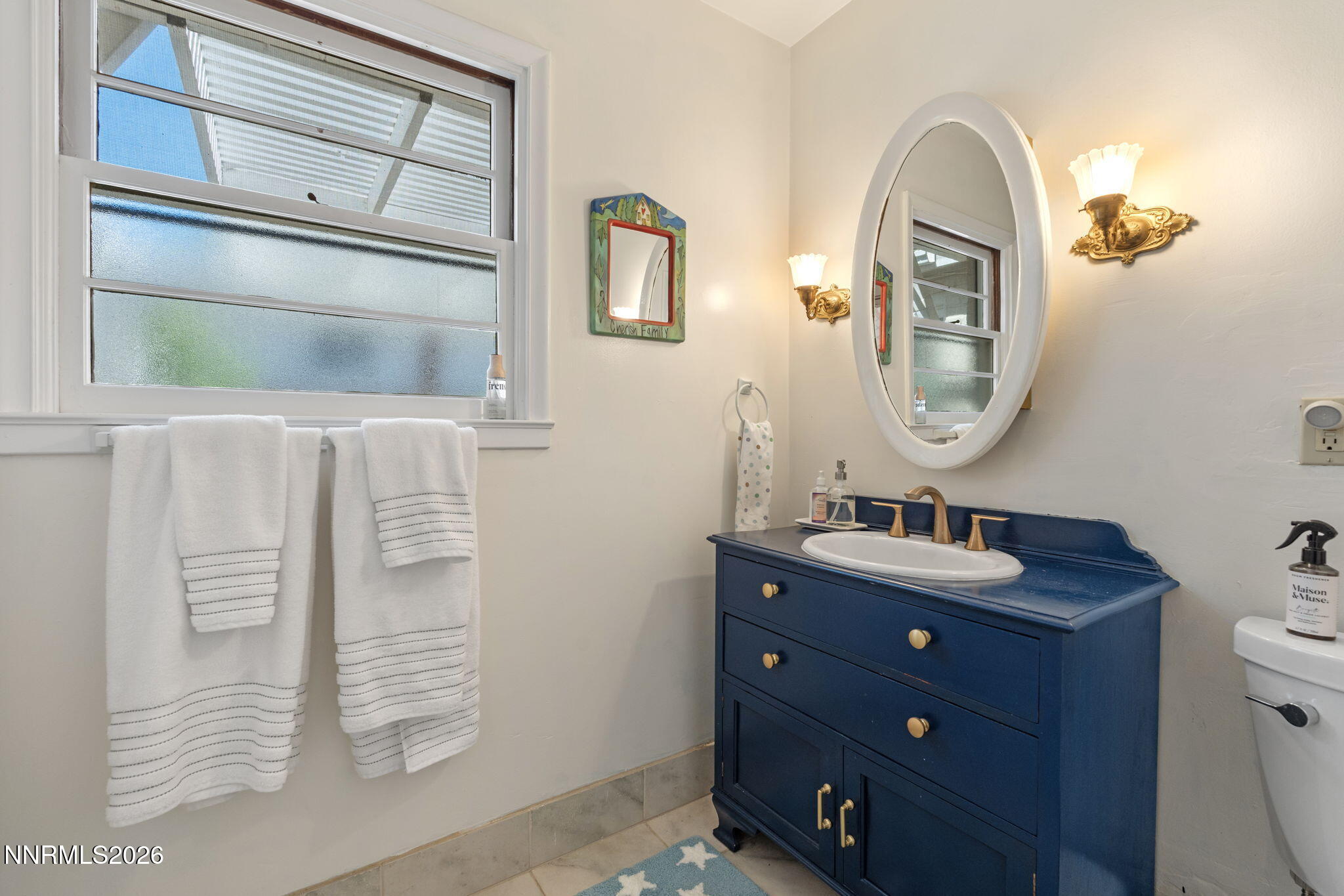 300 Country Club Drive Reno, NV 89509 - Photo 23 of 48 a bathroom with a sink a mirror and a toilet