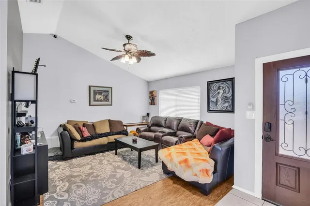 a living room with furniture ceiling fan and a rug