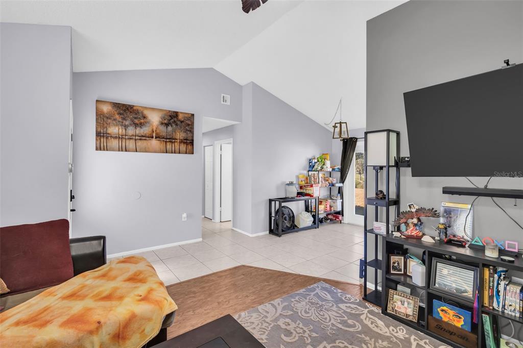 8425 Redfield Drive Port Richey, FL 34668 - Photo 4 of 13 a bedroom with furniture and a wooden floor