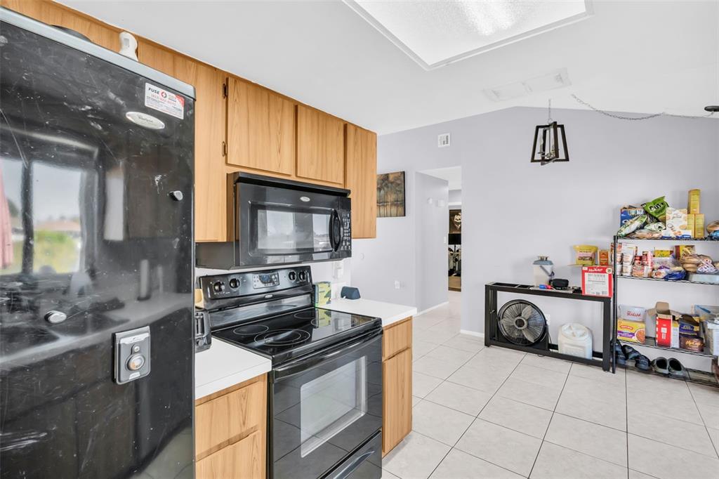 8425 Redfield Drive Port Richey, FL 34668 - Photo 5 of 13 a kitchen with granite countertop a stove and a sink