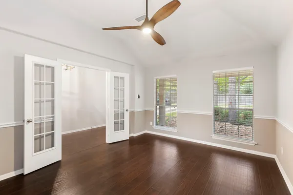 a view of a kitchen with a fireplace a ceiling fan and wooden floor