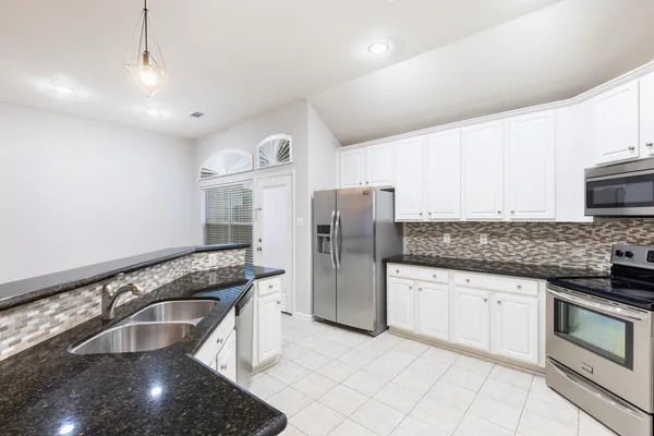 a kitchen with granite countertop a sink and a granite counter tops