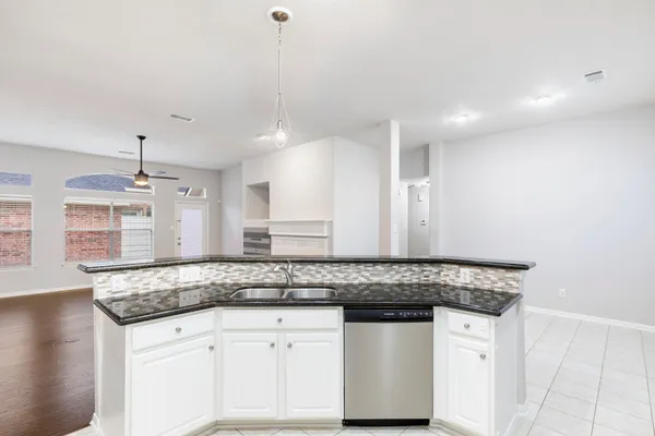 a kitchen with stainless steel appliances granite countertop a sink stove and cabinets